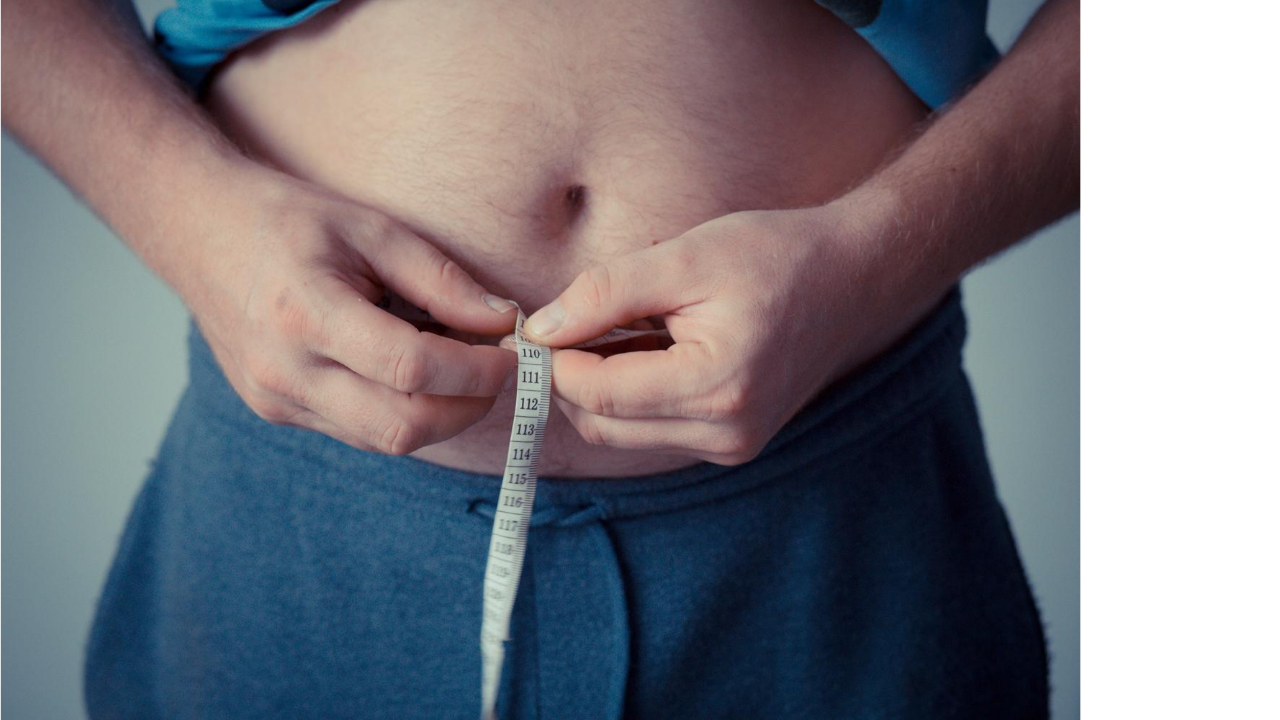 fat man measuring gut