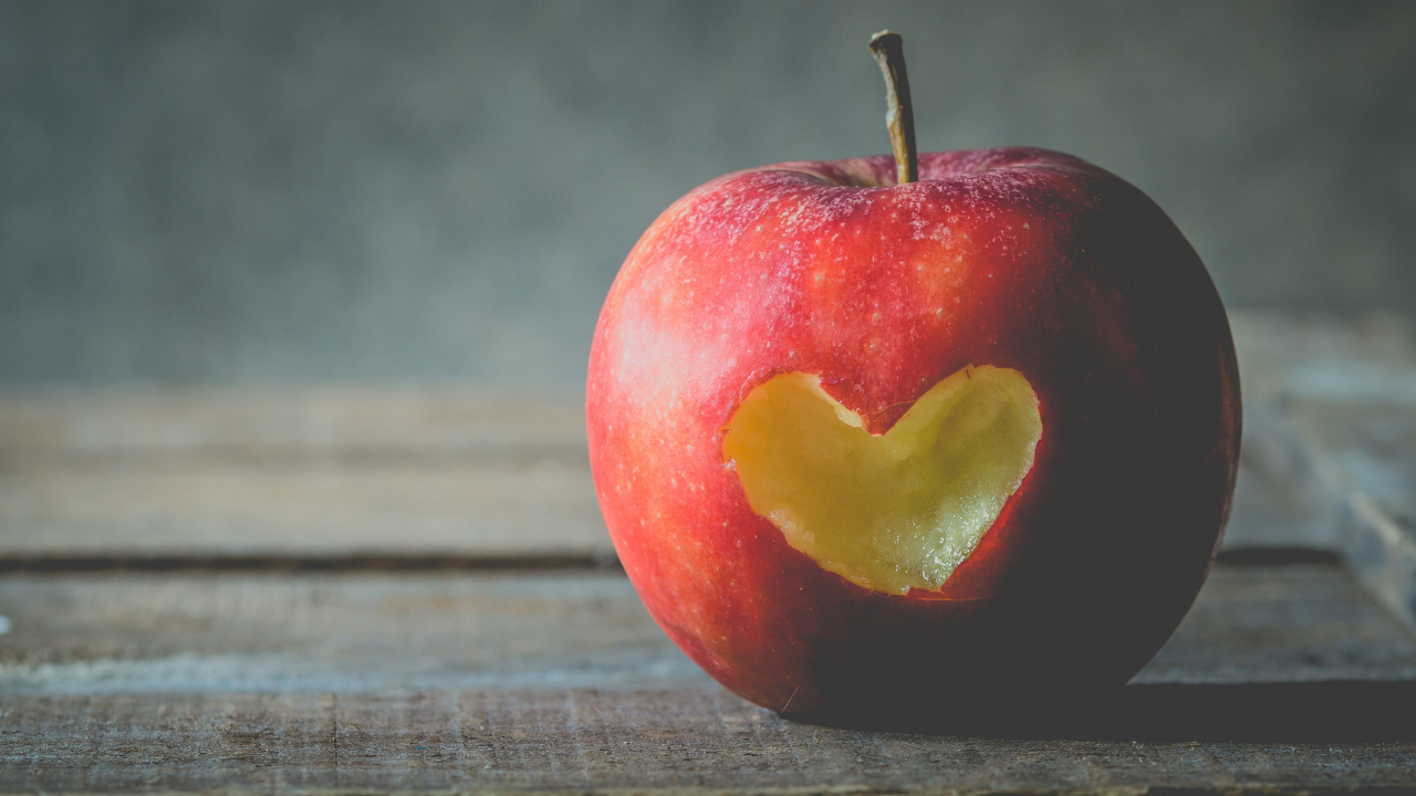 heart shaped chunk out of apple Apple with a heart bitten out of it