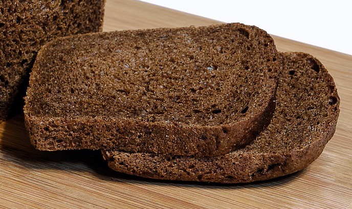 2 slices bread two rye flour slices of bread on breadboard